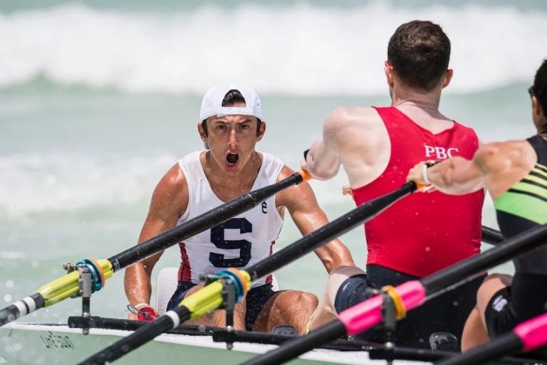 Bennett Rossell coxing in a coastal rowing race